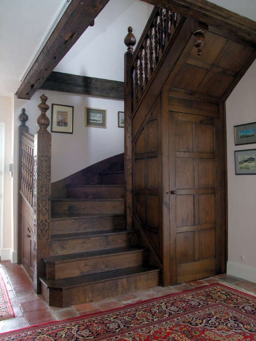 Oak Staircase with Hand Carved Newels, Turned Spindles and Cupboard under,the octagonal centre post gives maximum clearance on Stairs