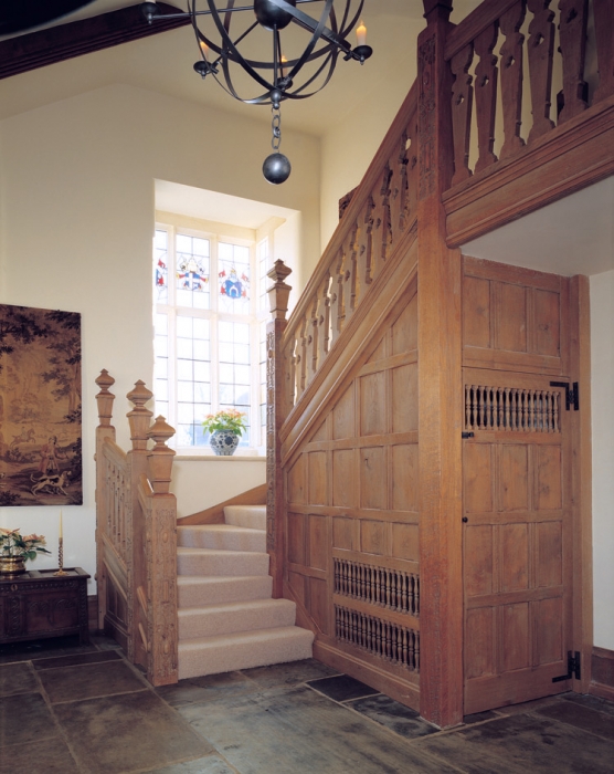 Oak Staircase with Hand Carved Newel Post and Fretted Splats, Turned Spindles leave air space for heating in Understairs Cupboard.