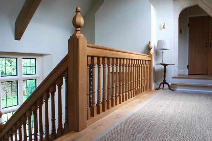 Light Oak Gallery with Heavy Sectioned Newel Posts and Handrail, and Faceted Newel Caps