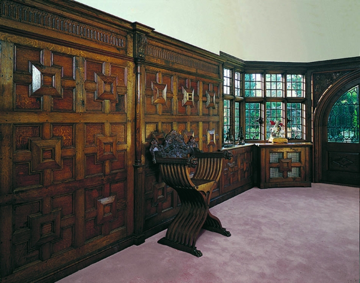 Geometric Oak Panelling with Turned and Carved Pilasters and Carved Frieze