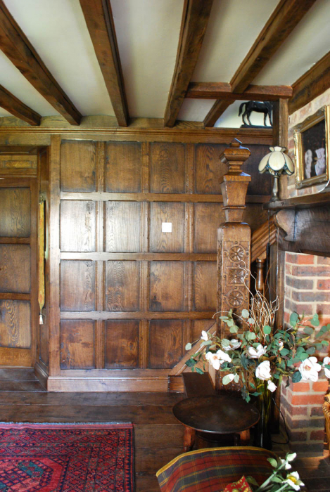Fitted aged oak wall panelling and hand carved newel post.