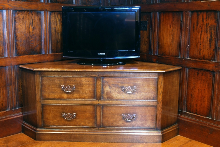 Distressed Oak Corner Television Cabinet with Brass Handles, the bottom left drawer is false, it is a Drop Down Flap with an adjustable shelf inside to house Media Equipment