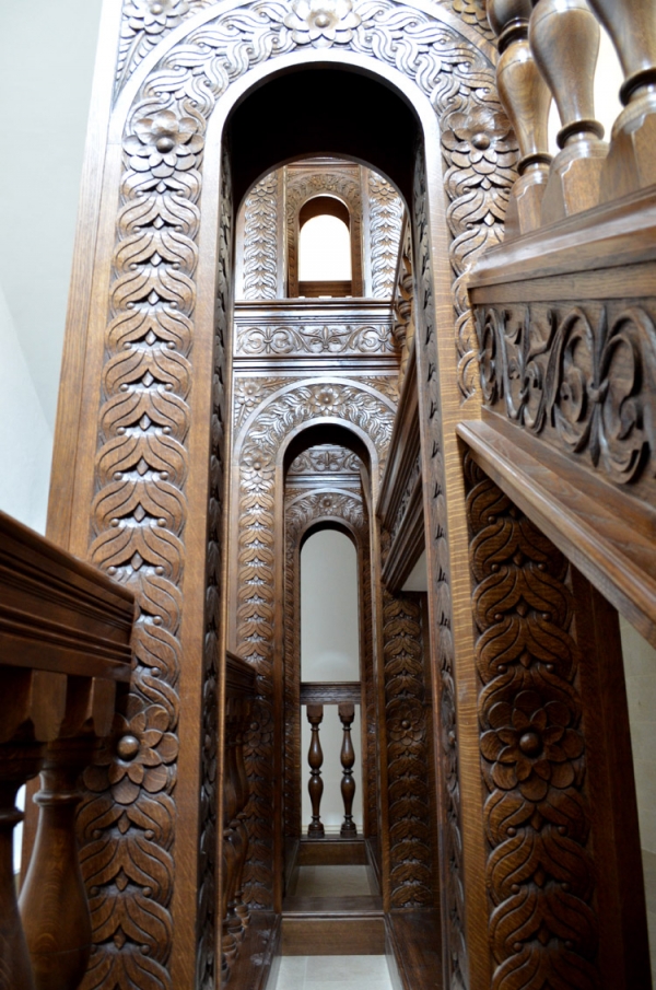 Oak Staircase, looking up through the arched columns and showing the Hand Carving of the Strings