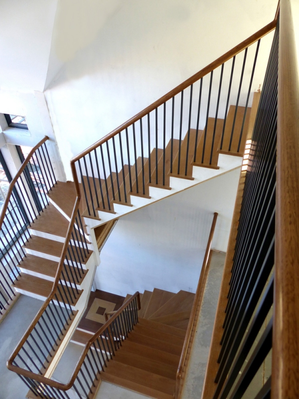 Contemporary Staircase with Oak Continuous Handrail, Oak Treads and Black Metal Balustrades
