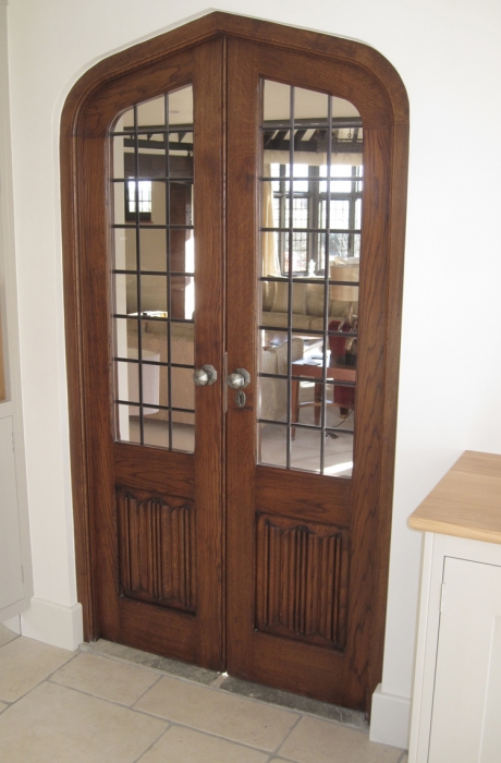 A Pair of Solid Oak Shaped Doors with Square Lead Light Glass and Linenfold Panels