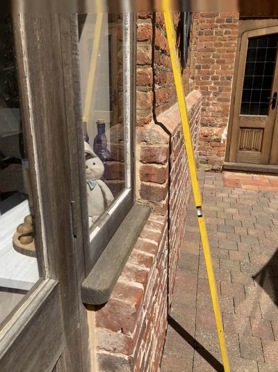 Measurements being taken and door to be matched in background
